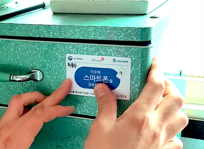 스마트폰을 태그 카드에 접촉해 출퇴근 기록하는 모습