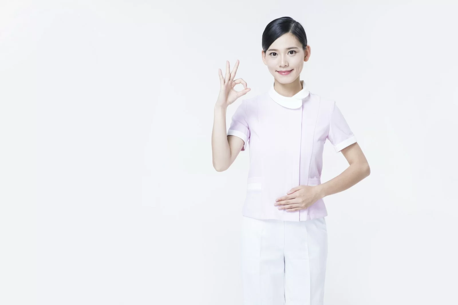 환하게 웃는 간호복 차림의 간호사