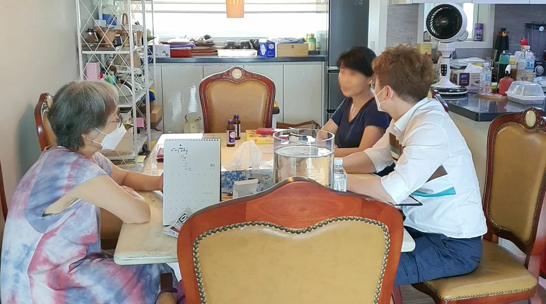 어르신 댁에서 보호자와 센터 직원이 상담하는 모습
