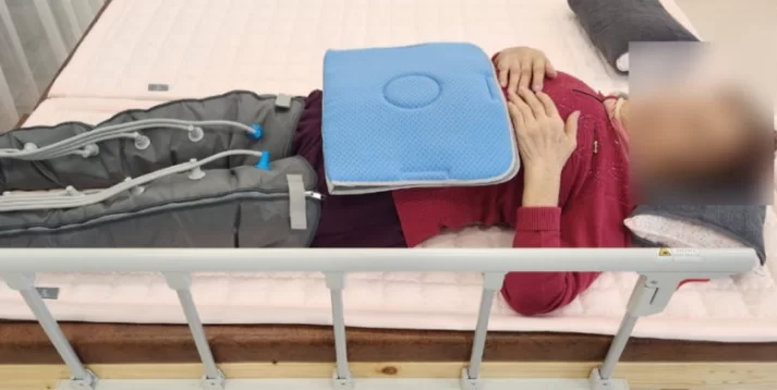 주간보호센터에서 어르신이 공기압 마사지를 받는 모습